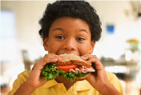 Photo of boy eating a healthy sandwich