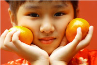 Photo of young asian girl with oranges